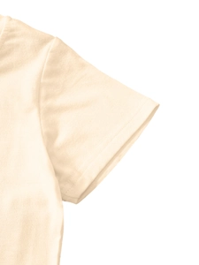 Detail of double-needle stitched cuff on beige cotton t-shirt for children