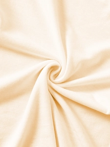 Detailed close-up of soft beige knit cotton fabric texture showing smooth ribbed material