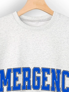 Detail of grey crewneck sweatshirt featuring blue EMERGENCY college style printed lettering