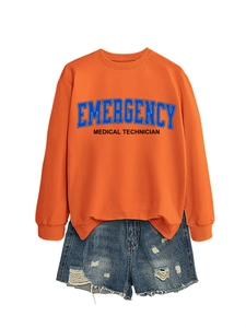 Detail of orange sweatshirt with Emergency Medical Technician print and denim shorts