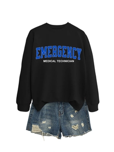 Flat lay of a black sweatshirt with EMT print paired with distressed blue denim shorts