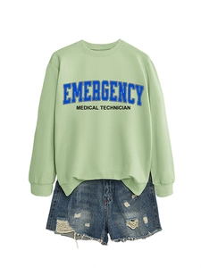 Detail of light green sweatshirt with Emergency Medical Technician print and denim shorts