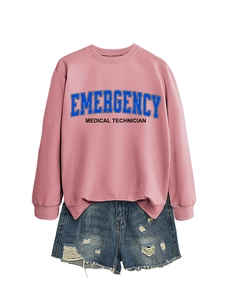 Flat lay of pink sweatshirt with emergency medical text and ripped denim shorts