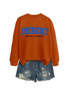Detail of emergency medical technician print on orange cotton sweater with denim shorts