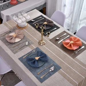 Close-up of golden Christmas tree napkin ring with linen placemat on a festive table