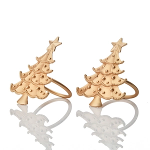 Close-up of golden satin finish Christmas tree napkin rings in a two-piece set