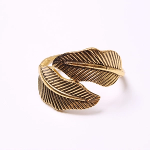Close-up of vintage golden leaf napkin ring with intricate vein details and antique finish
