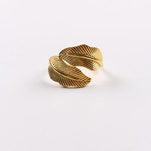 Macro shot of gold leaf napkin ring with detailed metallic veins and glossy finish