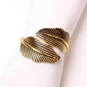 Macro shot of vintage gold leaf napkin ring with intricate feather texture and plating