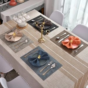 Golden reindeer head napkin ring on elegant two-tone linen tablecloth with lace trim