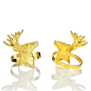 Pair of golden deer head napkin rings with metallic finish and detailed antler design