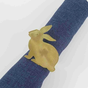 Golden bunny napkin ring set on a blue fabric napkin for Thanksgiving table decor