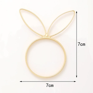 Golden bunny ear napkin ring close-up showing 7cm dimensions on white background