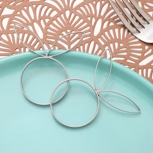 Silver rabbit-shaped metal napkin rings on a ceramic plate with a dining setup