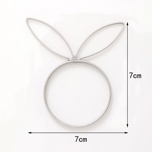 Macro detail of silver rabbit ear napkin ring showing 7cm dimensions on white background