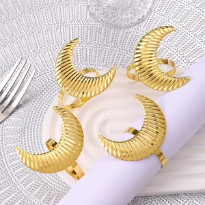 Set of 4 golden crescent napkin rings with elegant ribbed texture for table setting