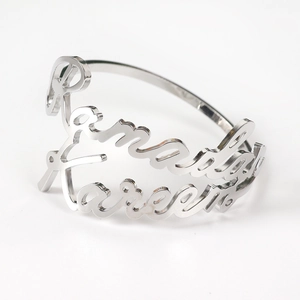 Close-up of silver Ramadan Kareem hollow lettering on a polished napkin ring