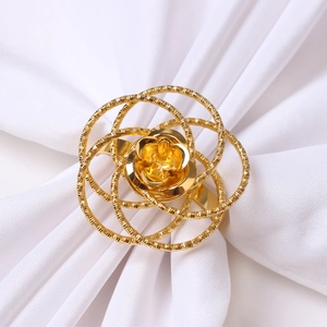 Elegant gold metal napkin ring featuring a hollow rose flower design for table setting