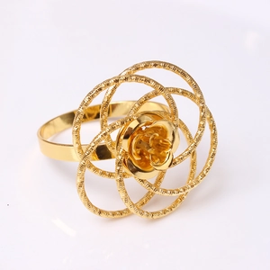 Elegant gold metal napkin ring featuring hollow rose flower design and hammered texture