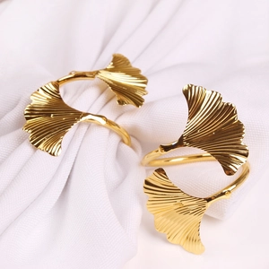 Golden ginkgo leaf napkin rings in polished metal for elegant wedding table settings