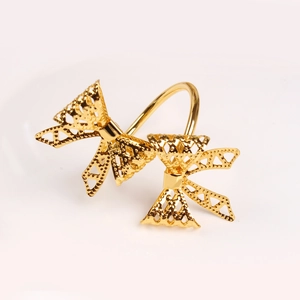 Elegant gold hollow bowknot napkin ring with intricate geometric mesh texture for weddings