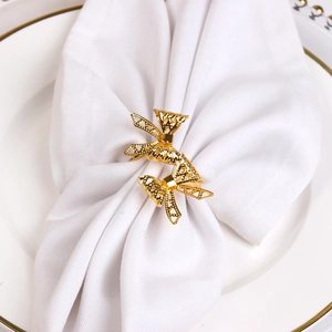 Set of two hollow bowknot metal napkin rings in gold finish for wedding table decor