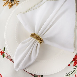 Luxury gold napkin ring with shimmering crystals on elegant white table setting