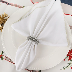 Close-up of sparkling rhinestone napkin ring on white plate with luxury festive decor