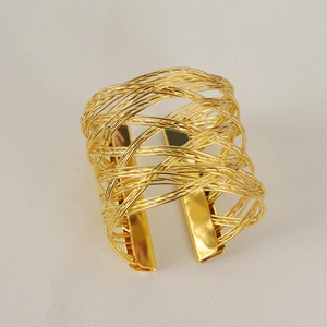 Golden woven mesh hollow napkin ring with modern metal wire texture for hotel table decor