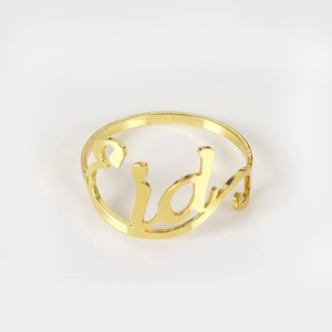 Macro view of gold metal napkin ring with hollow Eid script for festive table decor