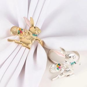 Detail of bunny napkin rings with flower baskets in gold and silver finish for Easter