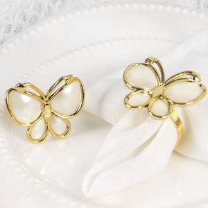 Golden butterfly napkin rings with faux shell inlay for elegant wedding table settings