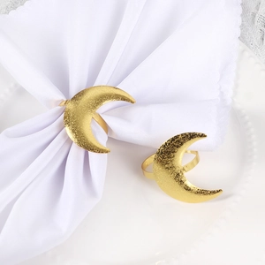 Pair of elegant matte gold crescent moon napkin rings for elegant dining table settings