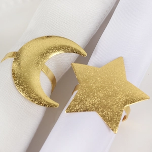 Frosted gold napkin rings with moon and star shapes for elegant dining table settings