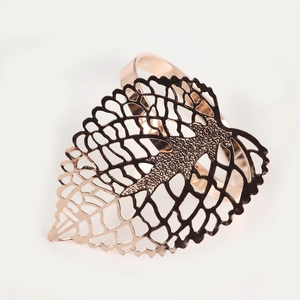 Close-up of rose gold hollow leaf napkin ring for elegant wedding table settings