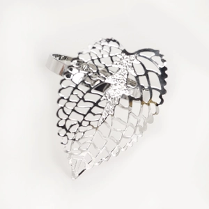 Detail of silver hollow leaf napkin ring with shimmering rhinestone embellishments