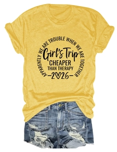 Detail of yellow Girl's Trip T-shirt and distressed denim shorts with frayed edges