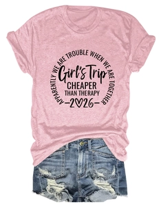 Detailed flat lay of pink cotton T-shirt with Girl's Trip print and ripped denim shorts