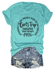 Flat lay of girl's trip t-shirt in teal with distressed denim shorts and print details