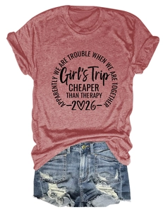 Flat lay of red Girls Trip cotton t-shirt paired with distressed denim summer shorts