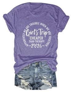 Detailed flat lay of purple Girls Trip 2026 t-shirt with distressed denim shorts