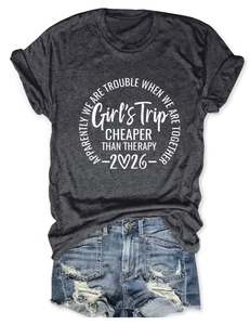 Detailed view of casual grey Girl's Trip print t-shirt paired with distressed denim shorts