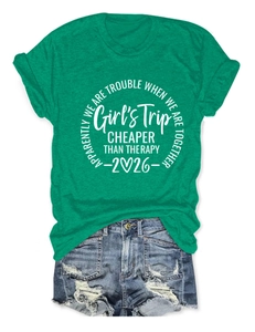 Close-up of green cotton T-shirt with white Girl's Trip print and denim shorts