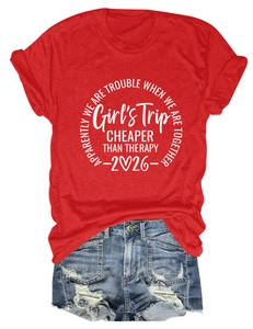 Red graphic T-shirt paired with distressed denim shorts showing frayed hems and prints
