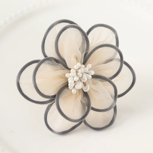 Detail of handmade double-layered mesh flower napkin ring with pearls and gray edging
