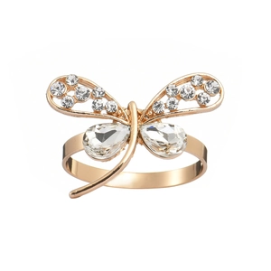 Elegant gold dragonfly napkin ring with sparkling crystals and rhinestones on white background