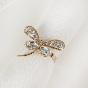 Detailed close-up of golden dragonfly napkin ring with sparkling rhinestones and gems