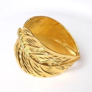 Golden double leaf napkin ring with intricate texture for elegant hotel table settings