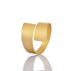 Golden plated wide open cuff bracelet with geometric triangular texture on white background