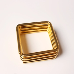 Modern gold square napkin ring featuring a minimalist four-layer geometric metal design